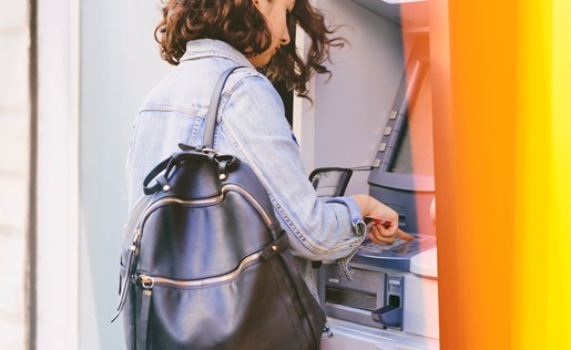 A woman withdrawing money from an ATM