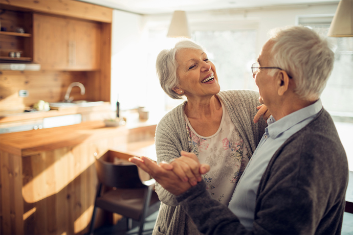 Older couple dancing in kitchen