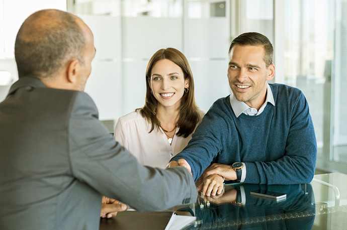 Couple at mortgage refinance meeting.