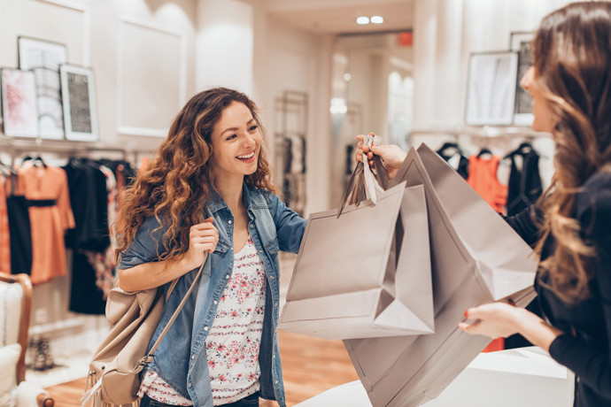 Female holding shopping bags in store