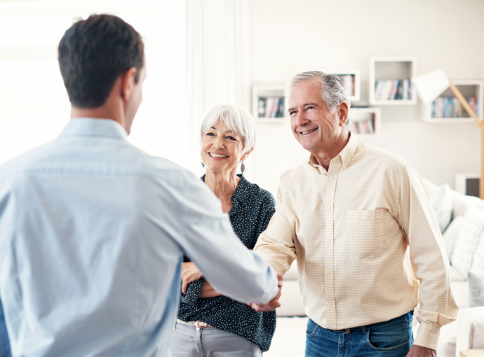 Shaking hands with older couple