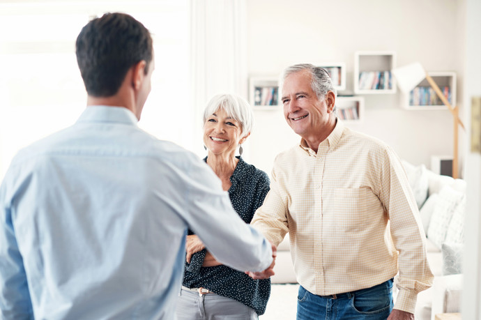 Shanking hands with older couple