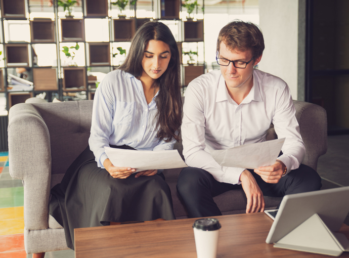 Man and women looking at documents