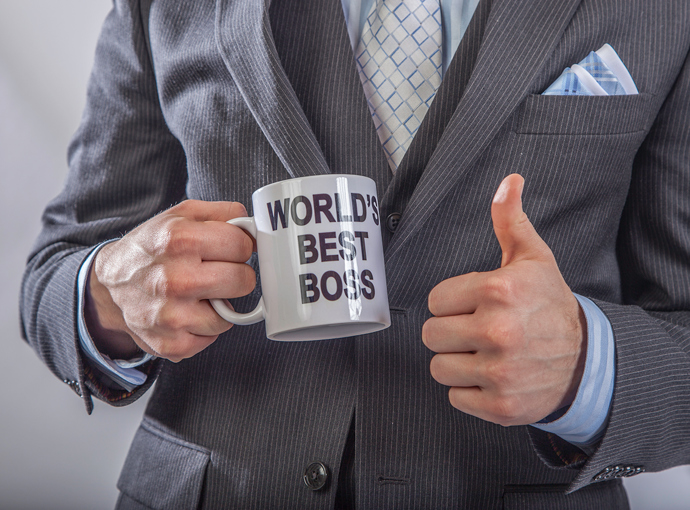 Holding "World's Best Boss" mug