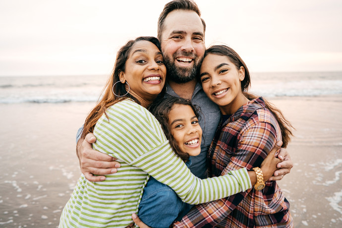 Family hugging each other on the beach