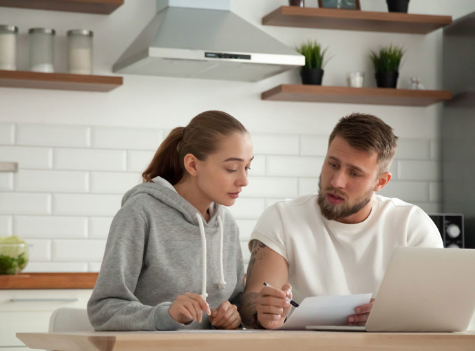 Young professional couple comparing bills