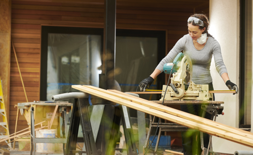 A woman woodworking to improve her home