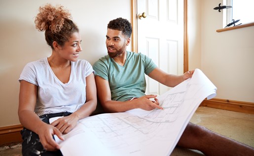 A couple planning home improvements with blueprints