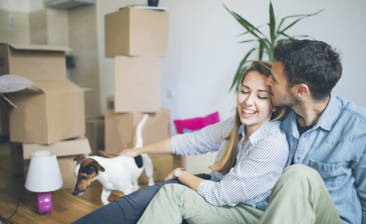 A couple kissing in their new home