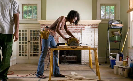 Woman doing some woodworking in her living room