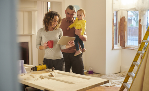 Couple with baby doing some renovations on their doors