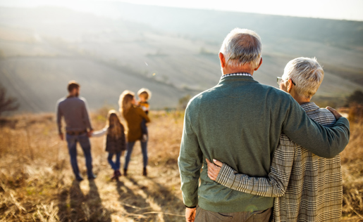 Older couple looking at their family in the place the new home will be built