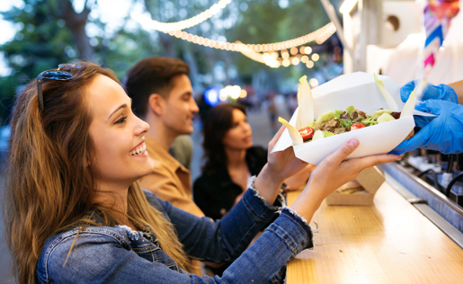 A woman buying food from a food truck