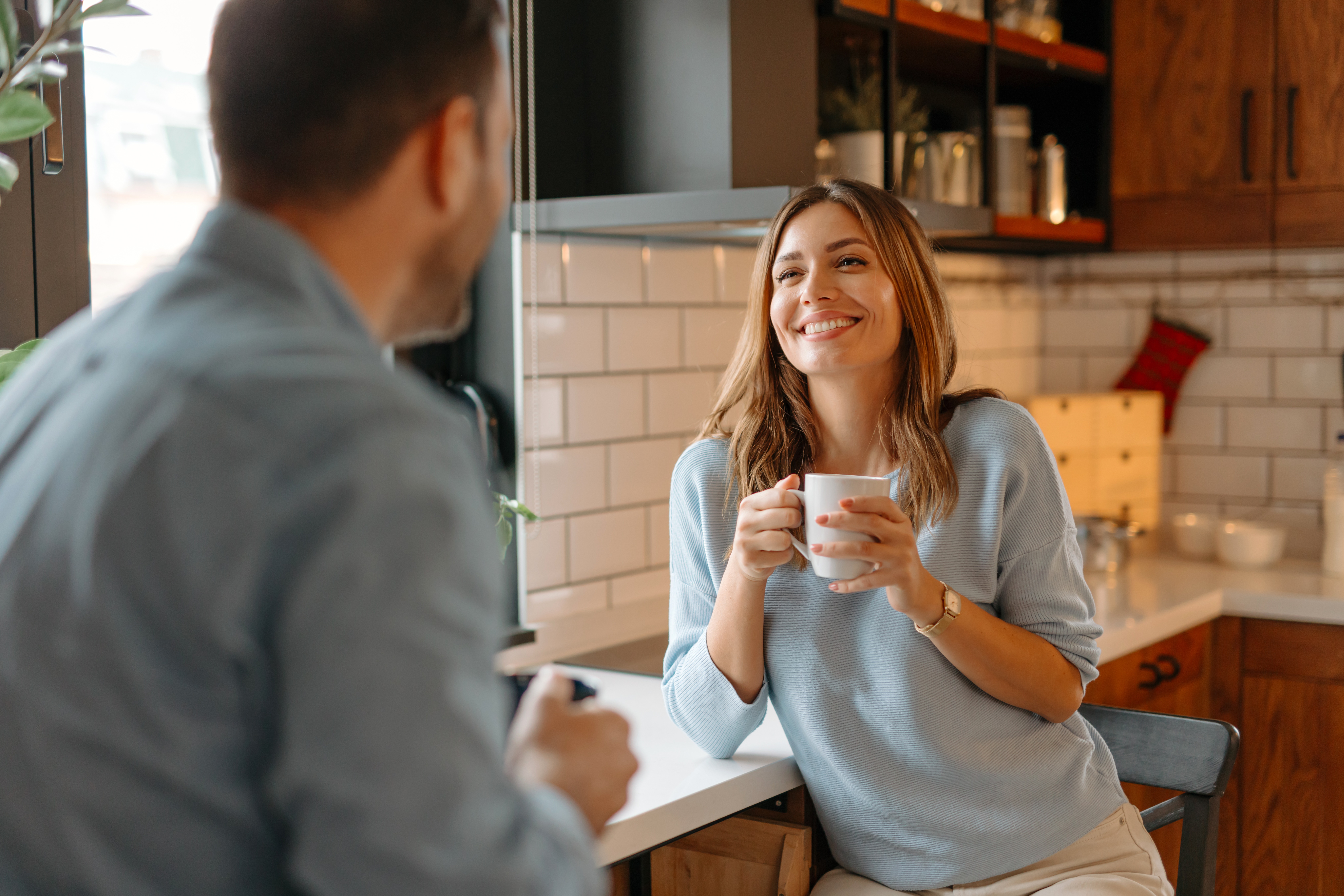 Woman smiling while holding coffee cup