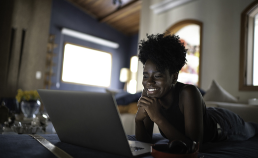 A woman enjoying Netflix on her laptop