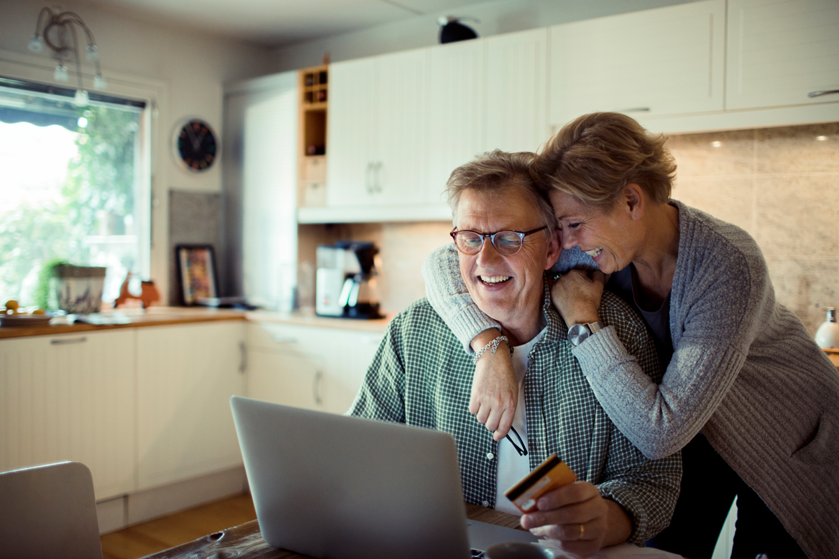 Couple making an online purchase with their credit card.