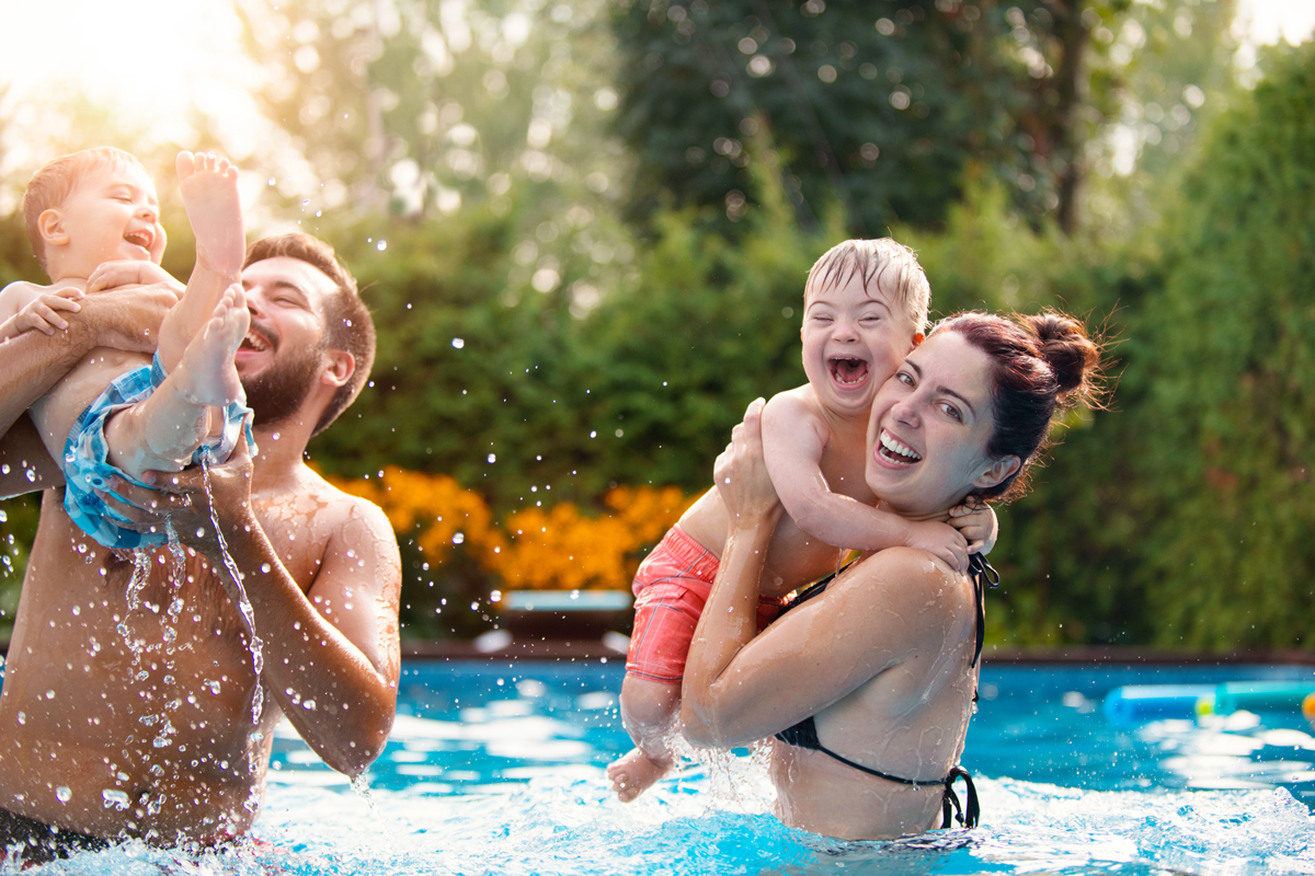 Family playing in the swimming pool.