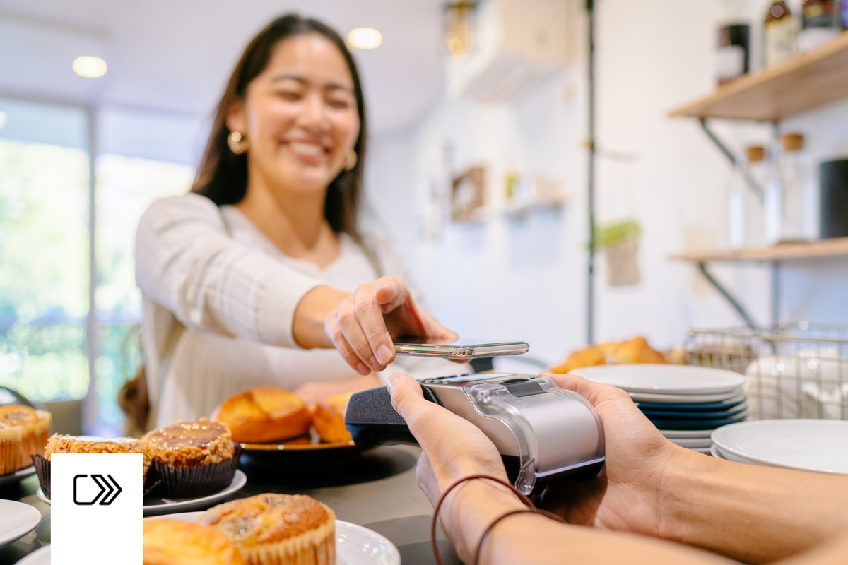 Woman paying with her iPhone.