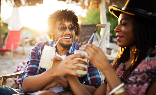 Friends drinking lemonade with straws in the sun.