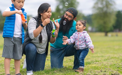 A family blowing bubbles outside