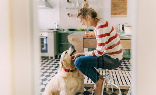 A woman and her dog in the kitchen