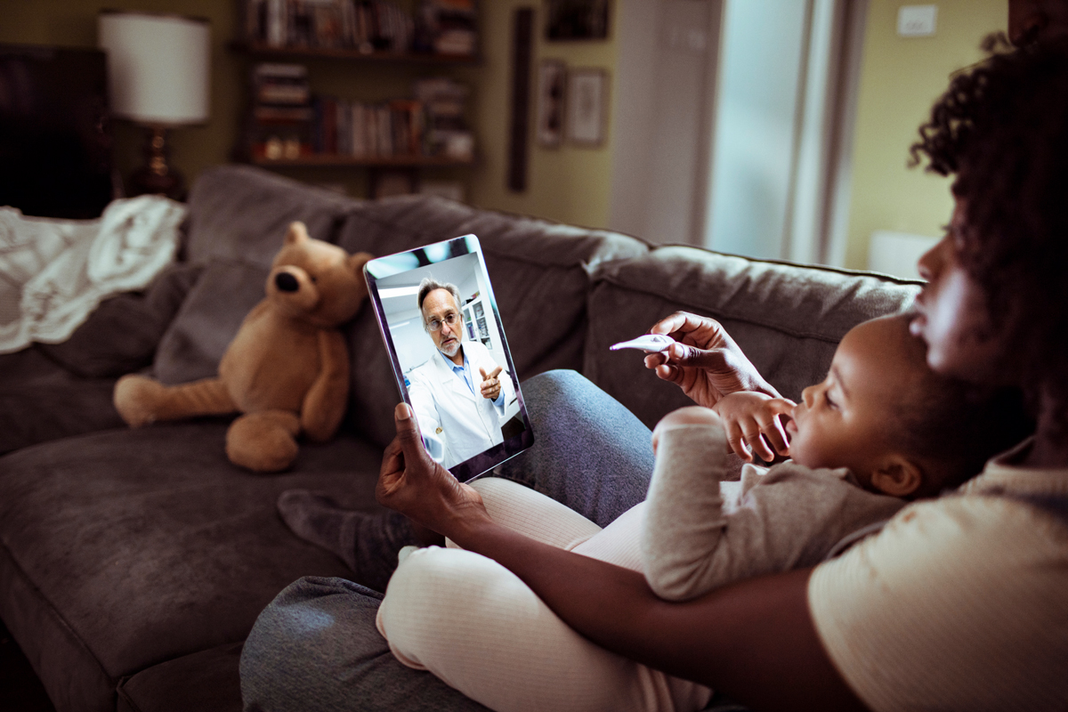 Woman and child talking to doctor on tablet.