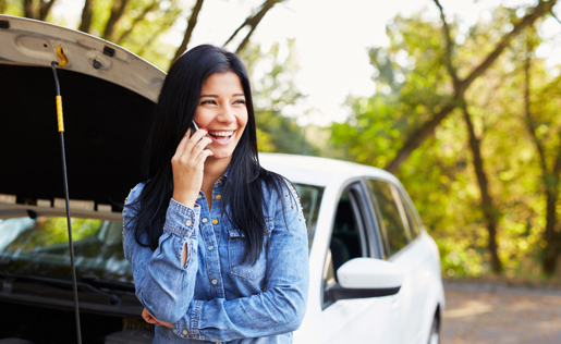 A woman calling for help because of a broken down car