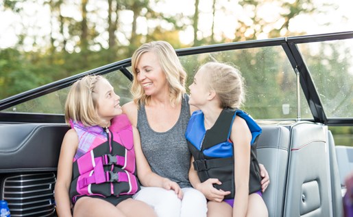 A mom and two girls on a boat