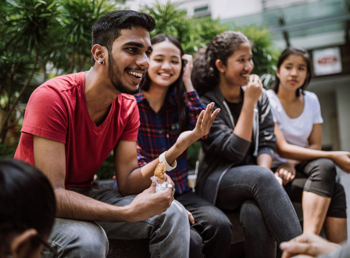 Students in college quad talking.