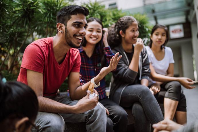 Students in college quad talking.