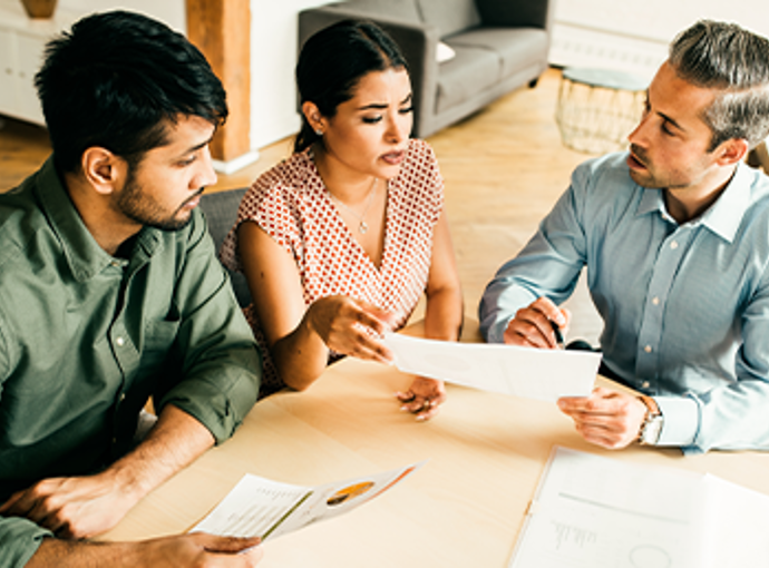 A couple speaking to their new financial advisor.