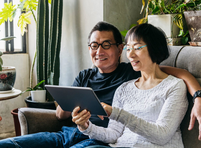 Couple watching a webcast on their tablet.