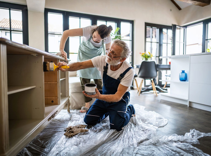 Father and daughter renovating a kitchen.