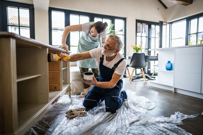 Father and daughter renovating a kitchen.
