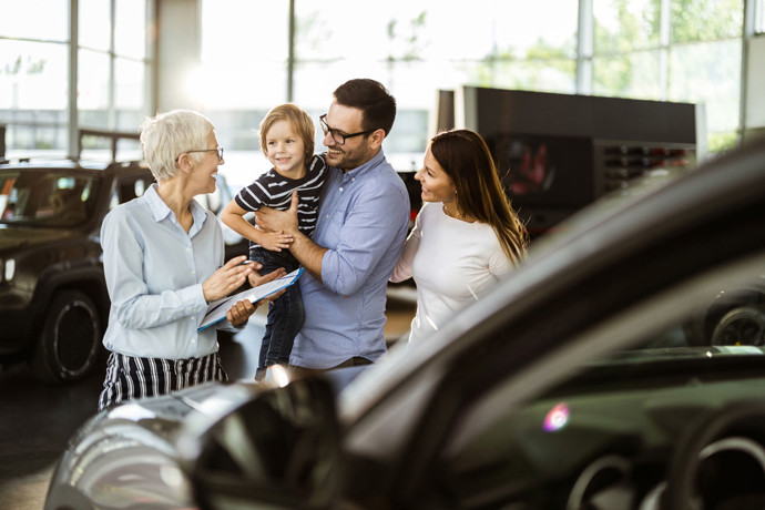 Family in a car dealership.