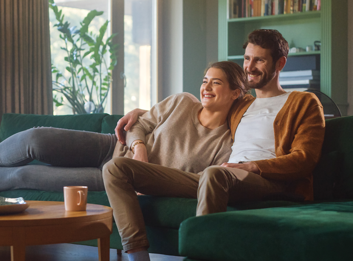 A couple sitting on their couch.