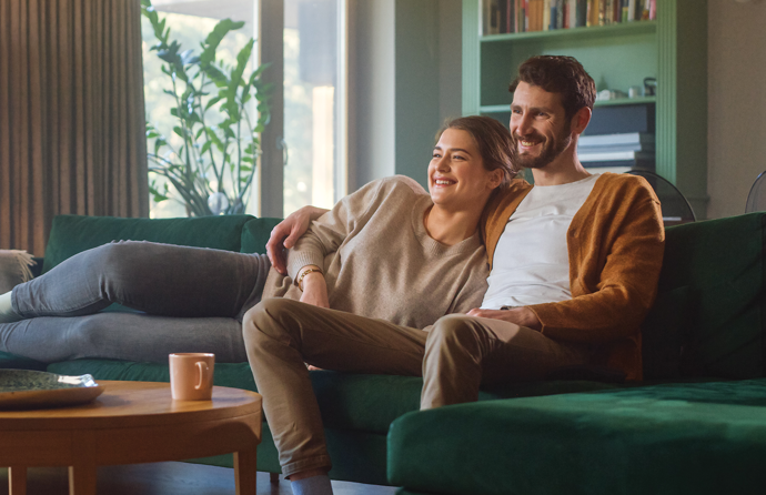 A couple sitting on their couch.