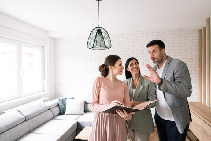 A couple and their Realtor looking at a new home