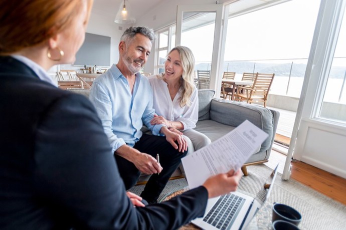 A couple talking to their insurance advisor.