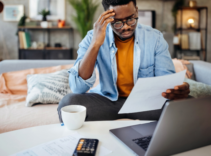 A man checking his bills at his laptop